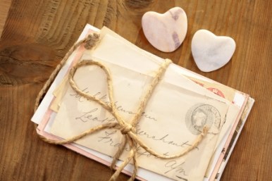 12775040 - stone hearts with old tied letters on wooden desk
