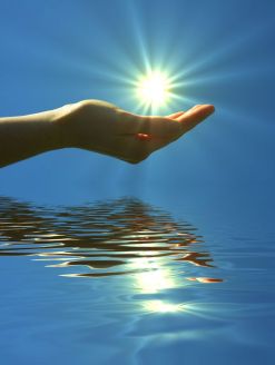 7322408 - hand holding sun and water reflaction with copyspace